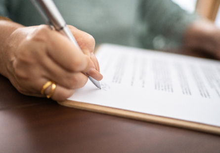 Woman signing estate litigation document