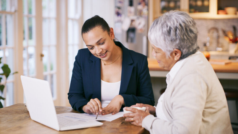 Older woman sitting with estate planning attorney